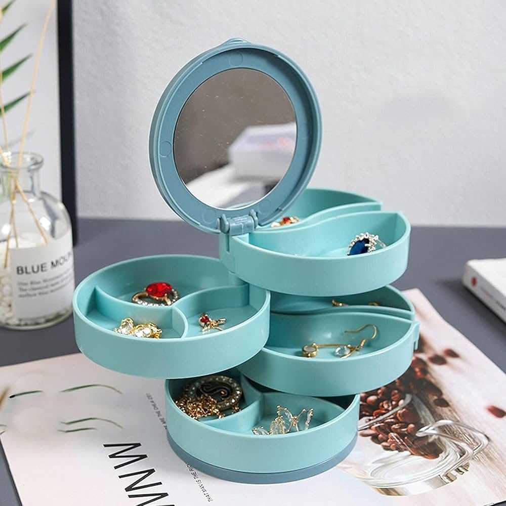Four-layer rotating jewelry organizer box with mirror, designed for jewelry storage and easy access.